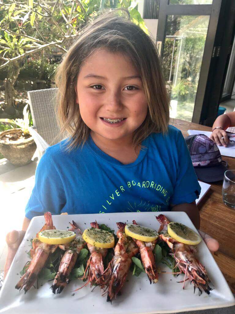 nusa dua seafood restaurants | nusa dua beach grill | young girl holding prawns 